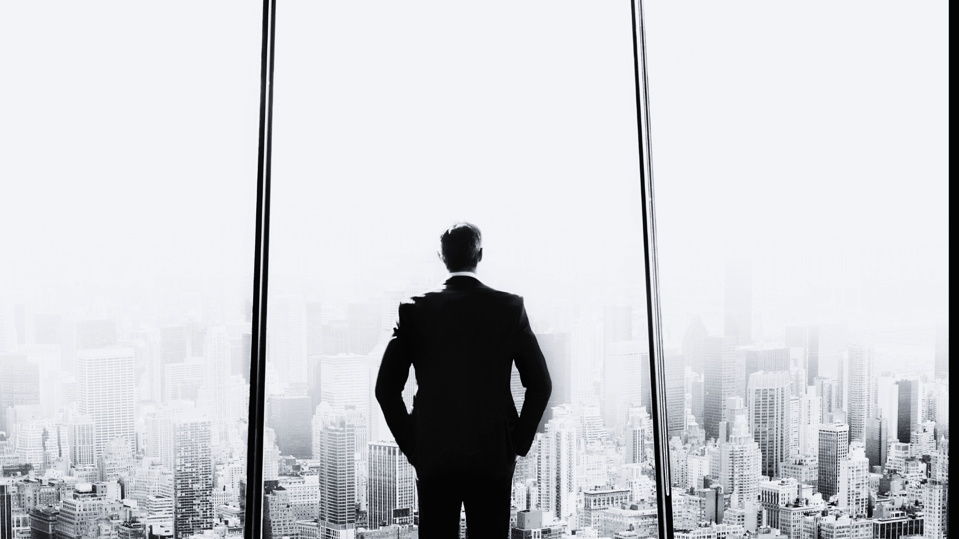 A CEO looking out over the city skyline at night